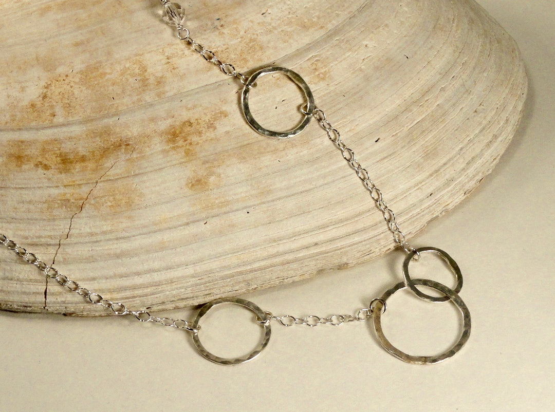 Circle necklace silver on sea shell
