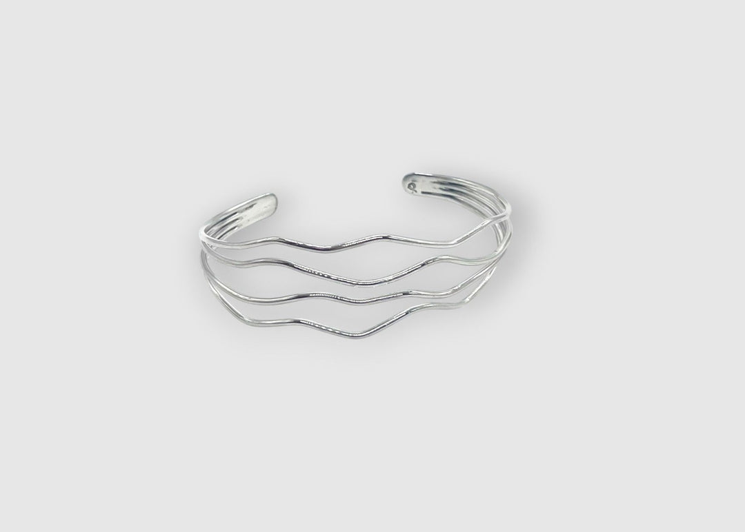 Multi band silver cuff bracelet on white background