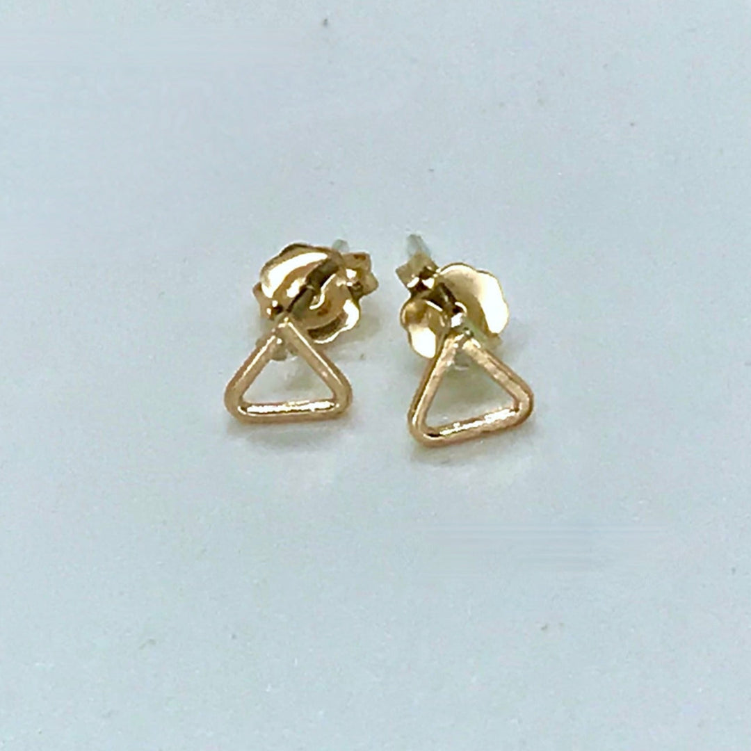 Gold post earrings triangles on white background