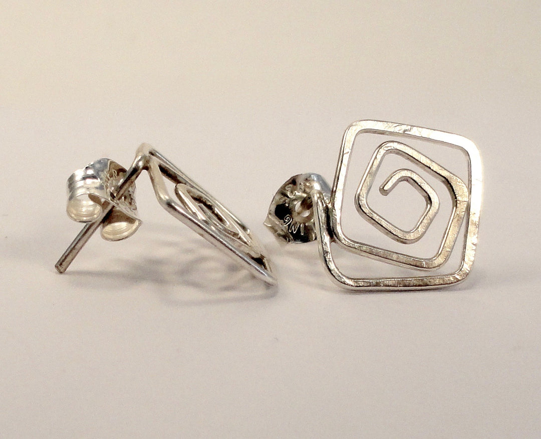 Square post earrings in silver on white background