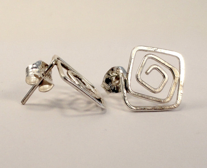 Square post earrings in silver on white background