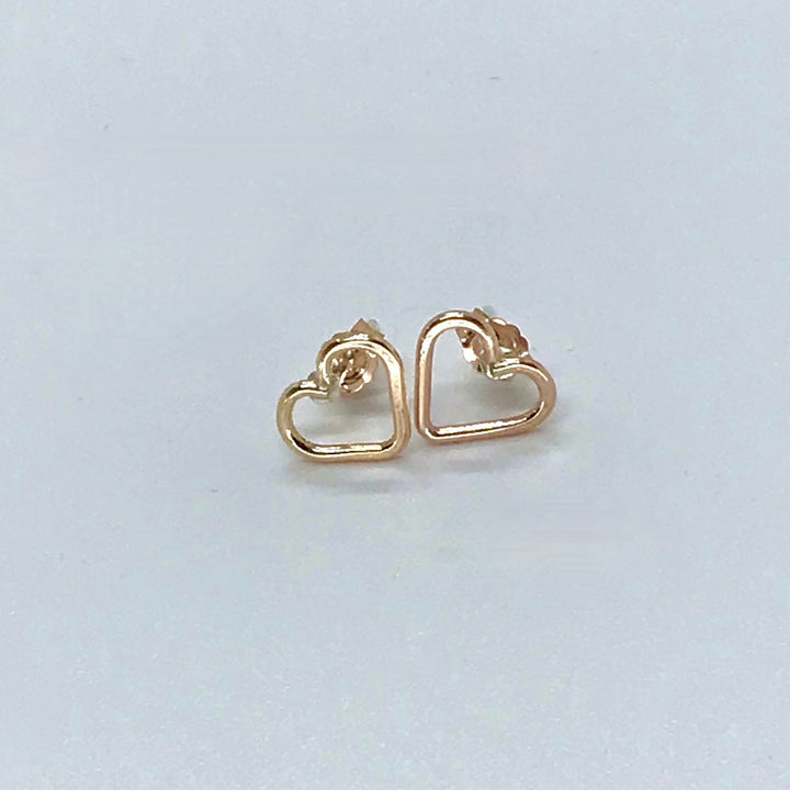 post earrings gold hearts on white background